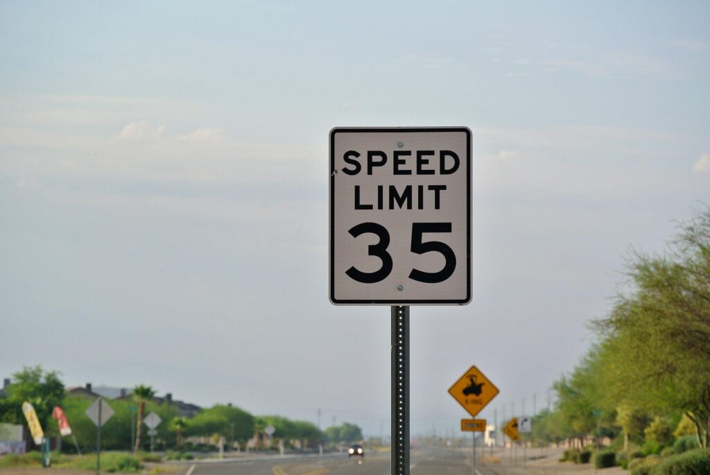A speed limit sign on the road. 