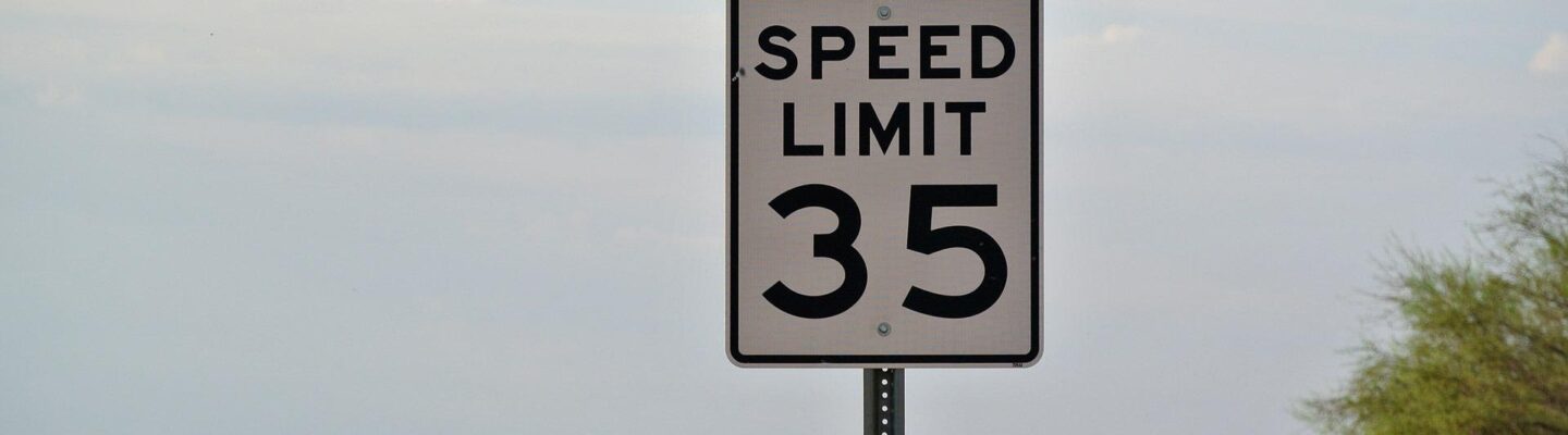 A speed limit sign on the road.